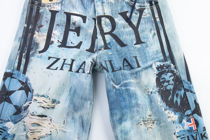Front upper view of blue baggy denim pants with large graphic lettering across the legs