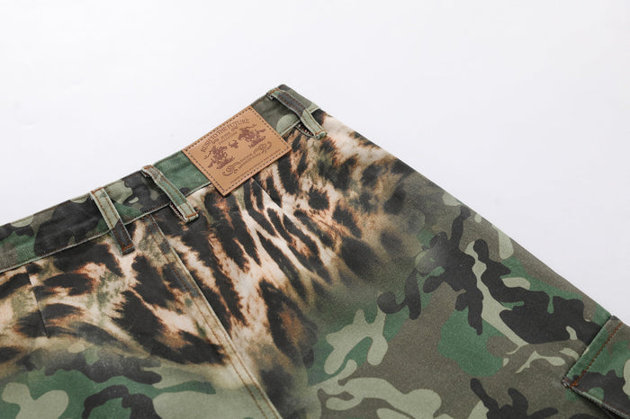 Close-up of the rear waistband with tan patch label and mixed camo leopard print