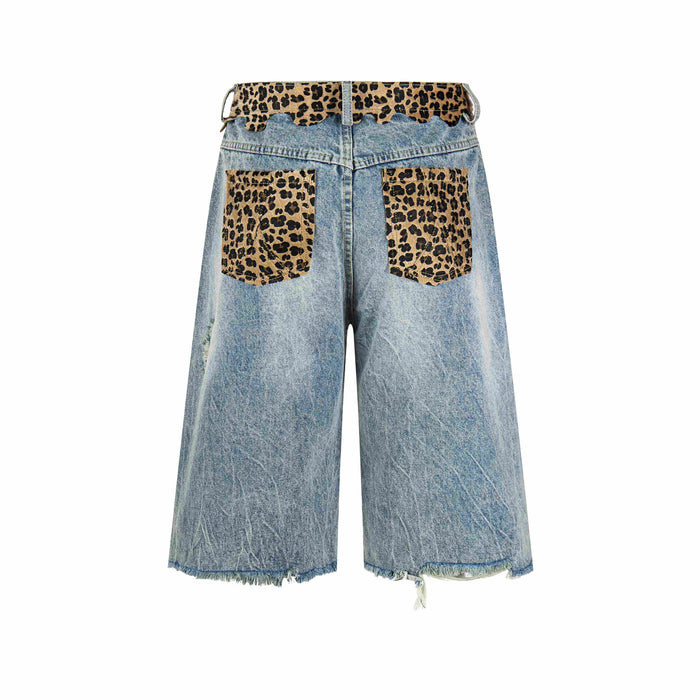 Back view of distressed denim shorts with leopard print patch pockets and scalloped waistband