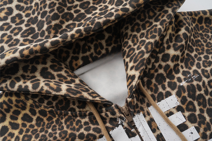 Close-up of leopard print hoodie hood, zipper, and chest graphic