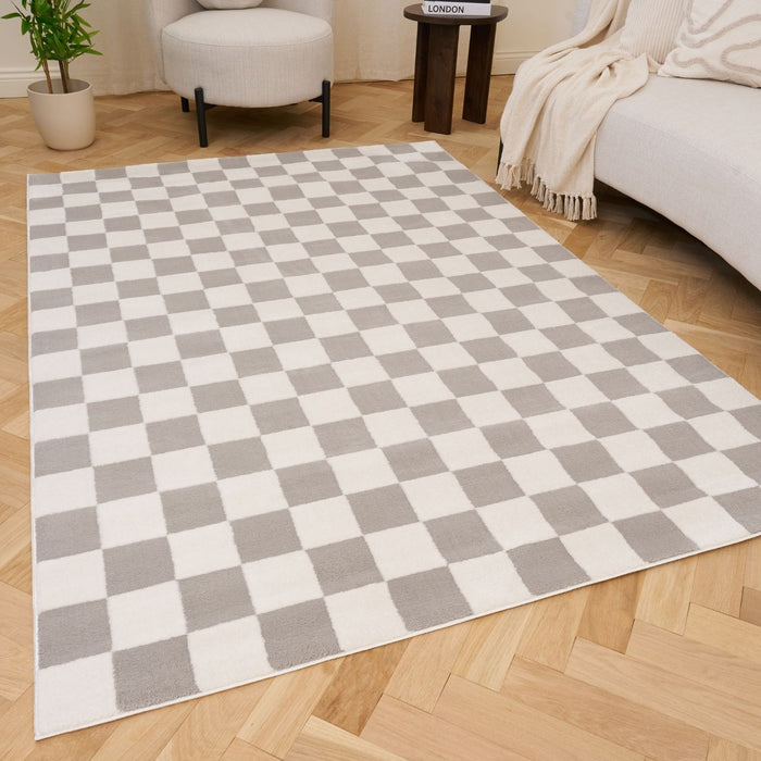 Checkered rug with gray and white squares on a wooden floor
