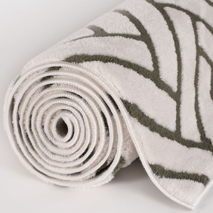 Rolled-up rug with leaf pattern on a light background