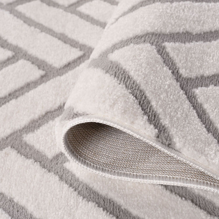 Gray textured rug with a patterned border