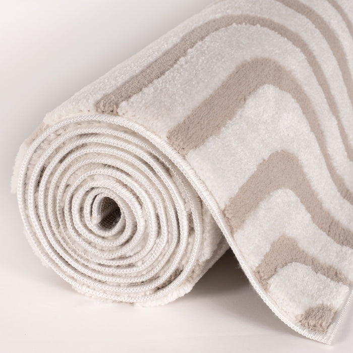 Rolled-up rug with chevron pattern on a light background