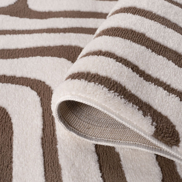 Close-up of a textured rug with brown and beige stripes