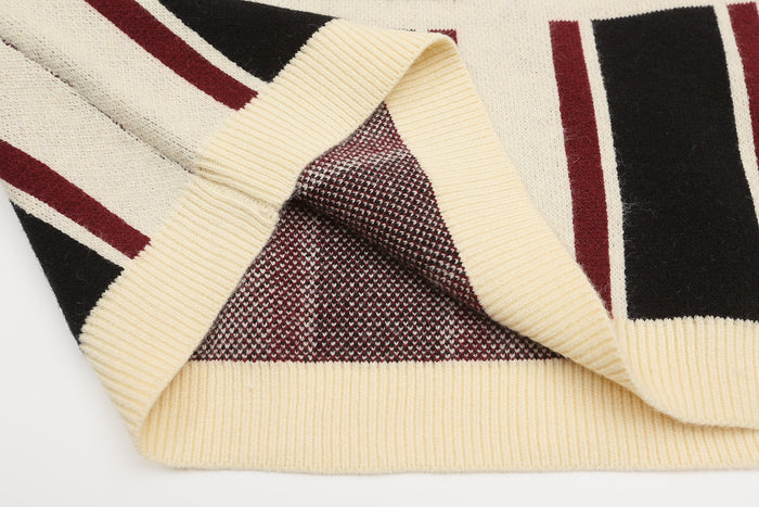 Inside hem and neckline detail of cream ribbed striped knit sweater