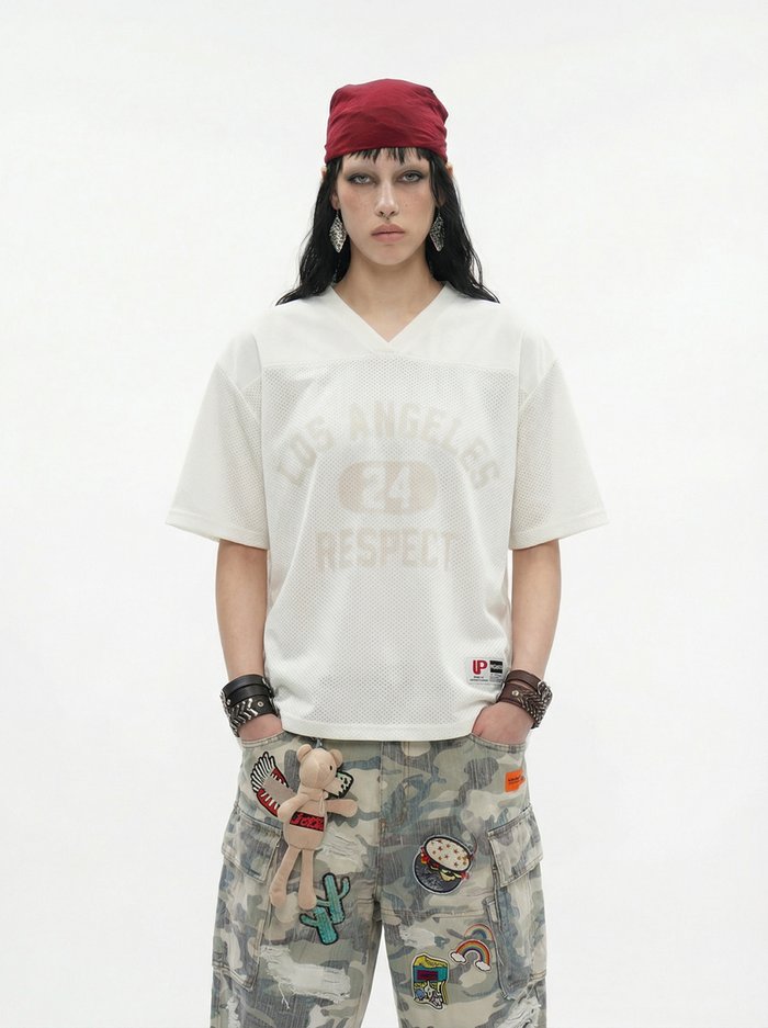 White Los Angeles 24 Respect V-neck mesh tee worn with camouflage cargo pants and a red headwrap on a model