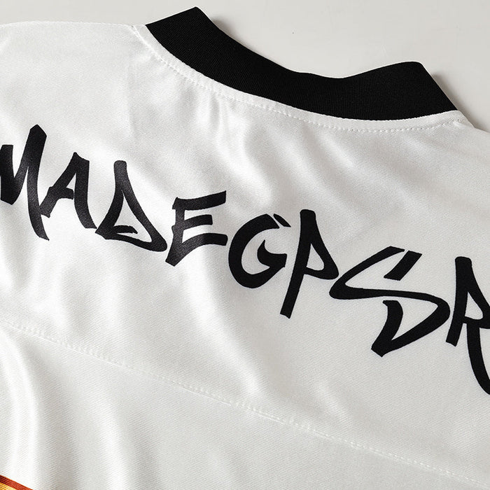White football jersey with black collar and bold graffiti-style MadeGPSR lettering on the back