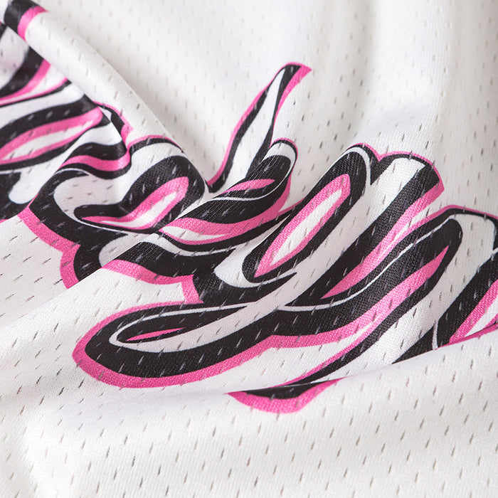 Close-up of a white mesh football jersey with bold pink and black graphic lettering for streetwear style