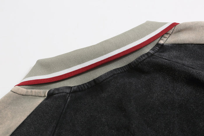 Striped ribbed collar and shoulder seam on black rugby sweatshirt with gray panel detail