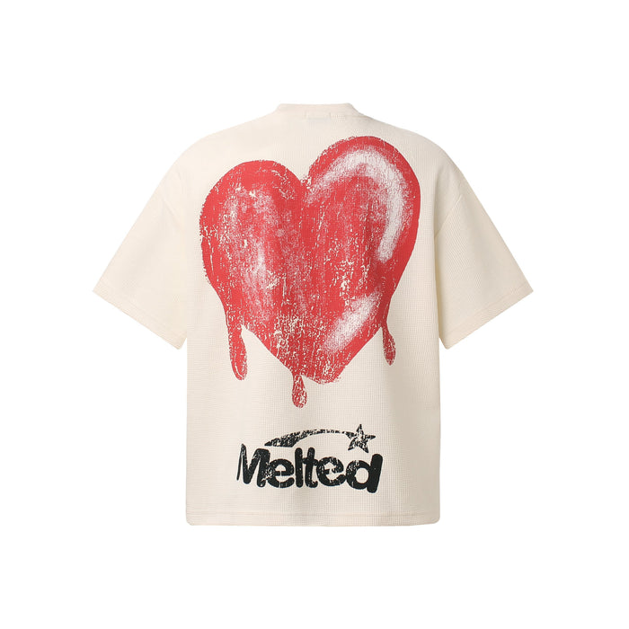 Cream oversized graphic tee with a large red dripping heart and distressed black Melted text on the back