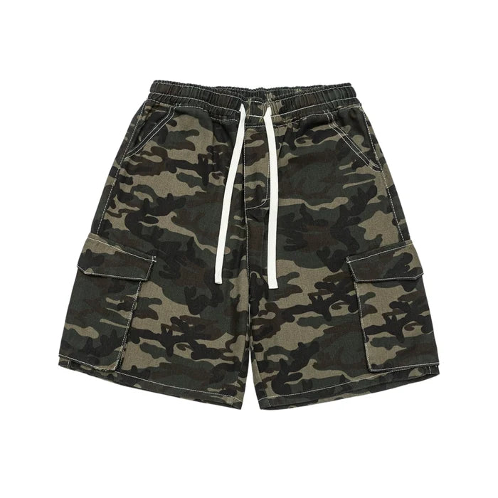 Men's baggy woodland camo cargo shorts with elastic drawstring waist, flap cargo pockets, and white contrast topstitching laid flat on white background