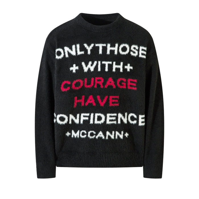 Black fuzzy knit crewneck sweater with bold white and red slogan text reading Only Those With Courage Have Confidence McCann