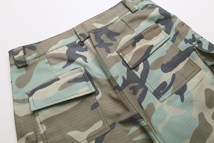 Close-up of back cargo pocket flaps on woodland camo shorts