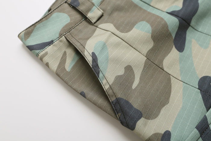Close-up of hem and side cargo pocket on woodland camo shorts