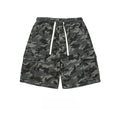 Men's dark grey and black woodland camo cargo shorts with elastic drawstring waist and oversized flap pockets on a white background