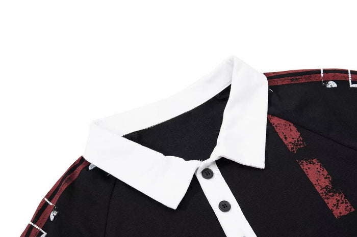 Black polo shirt with white collar and red vintage graphic accents, shown in a close-up of the neckline and buttons