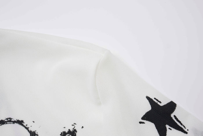 Close-up of white sleeve hem with black lightning and star print