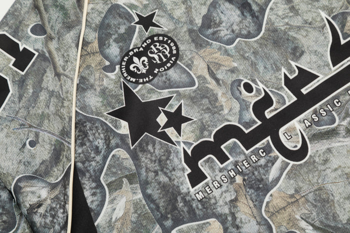 Close-up of upper chest graphic with star emblem and Mershier text on camouflage mesh jersey