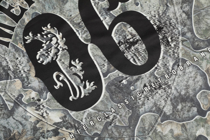 Close-up of back 06 graphic with partial Mershier Classic Retrobrand text on camo jersey