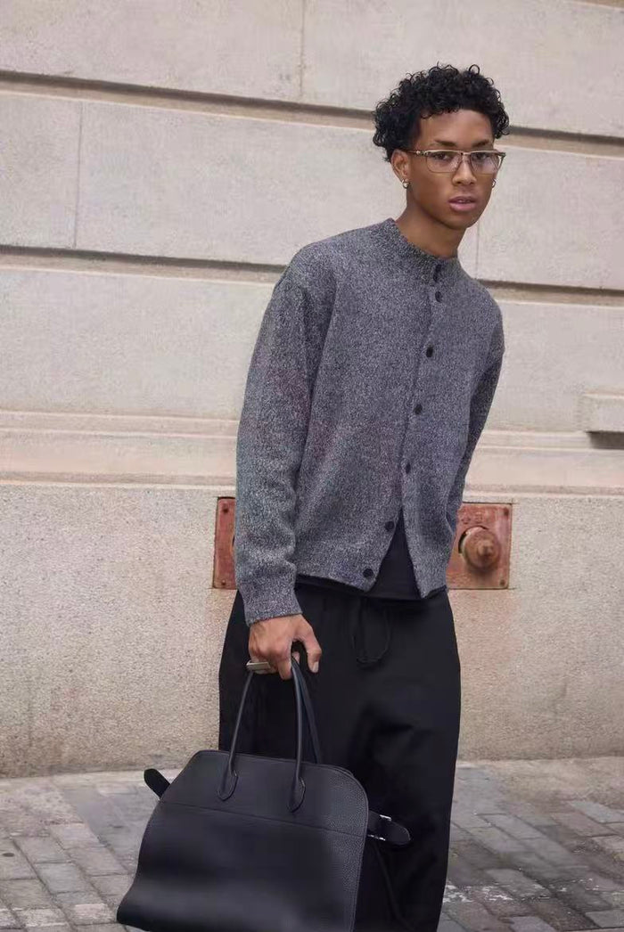 Gray cardigan worn at a slight angle with button front and long sleeves