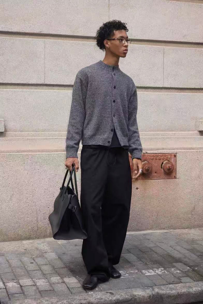 Gray cardigan worn standing in profile with front buttons visible