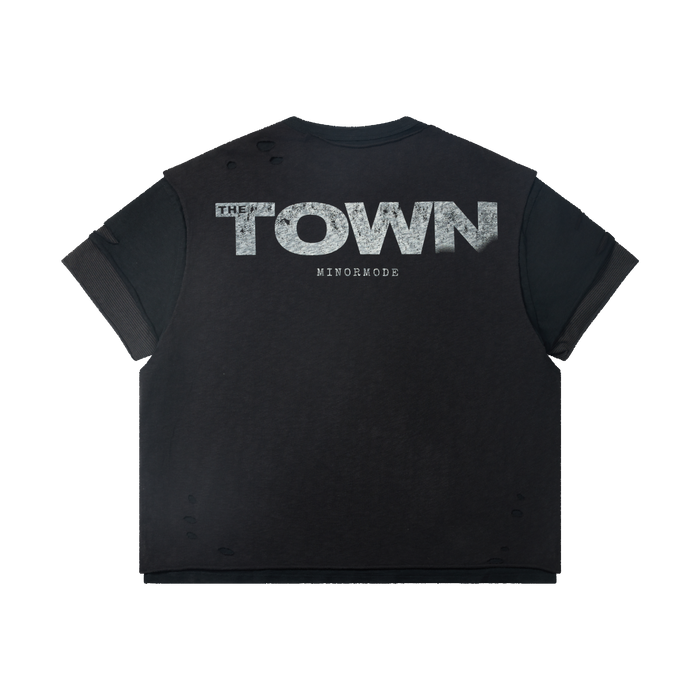 Washed black distressed graphic tee with layered sleeves and bold THE TOWN print on the back