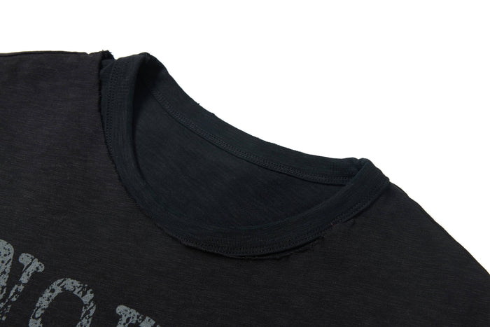 Washed black distressed graphic tee with layered neckline and faded print detail