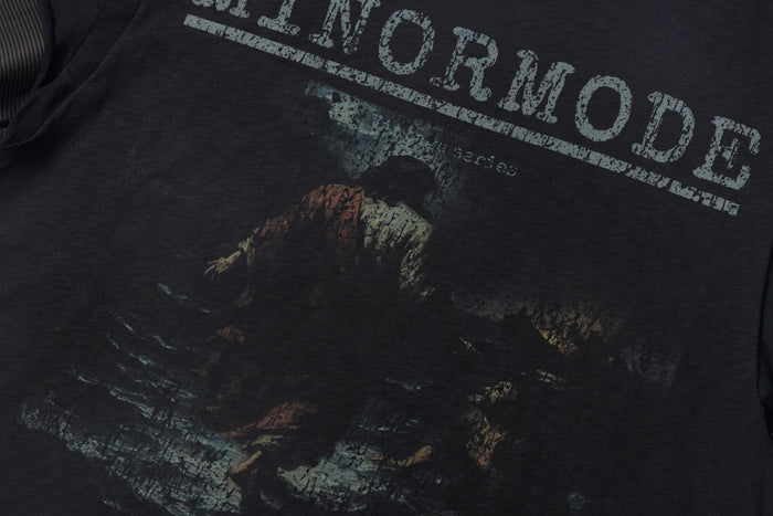 Washed black distressed graphic tee with faded vintage print and layered oversized lettering