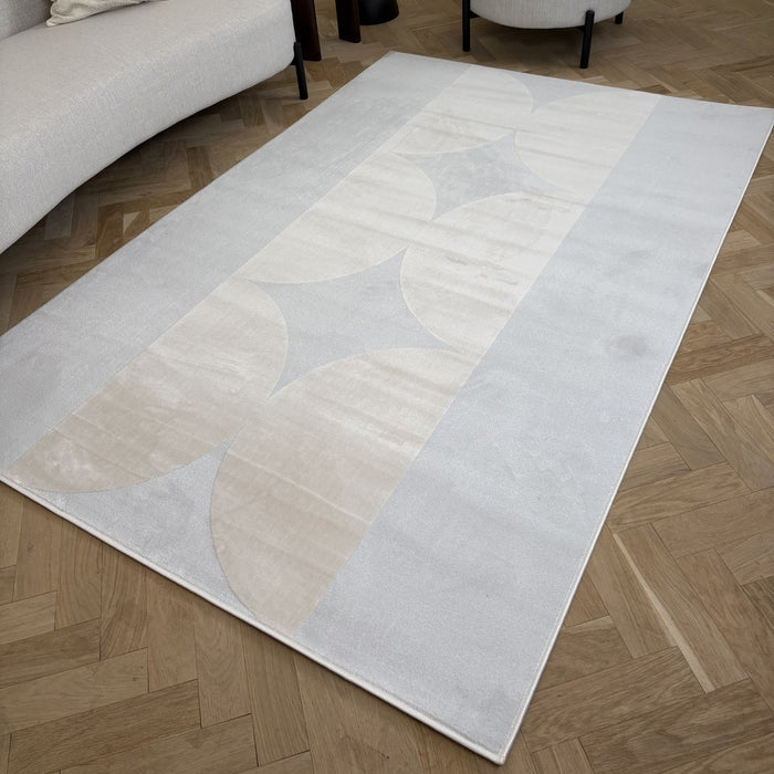 Rectangular area rug with abstract pattern on a wooden floor