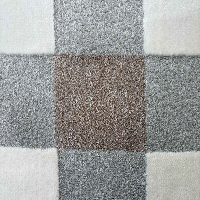 Close-up of a checkered pattern with gray, white, and brown squares.