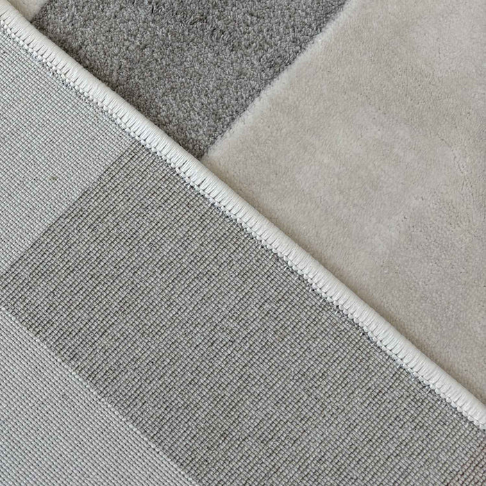 Close-up of various gray and beige rug samples.