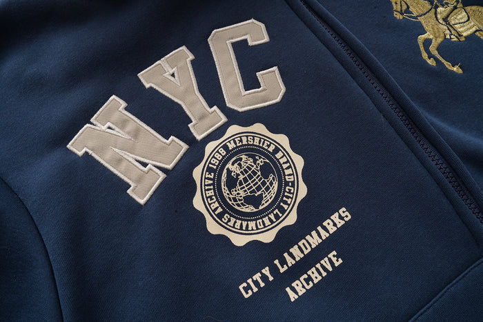 Close-up of large NYC varsity lettering and city emblem on navy hoodie front
