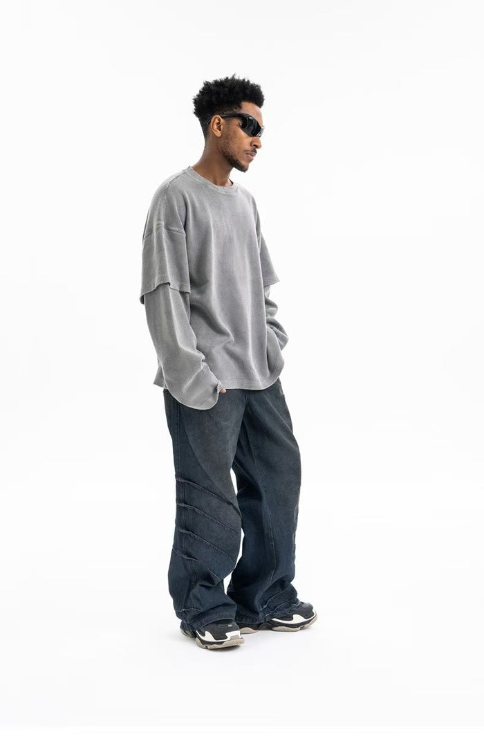 Side view of gray oversized crewneck sweatshirt on model with loose fit