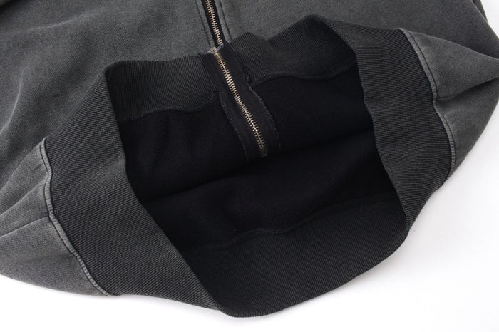 Open hood close-up showing black ribbed lining and zippered front on dark gray hoodie