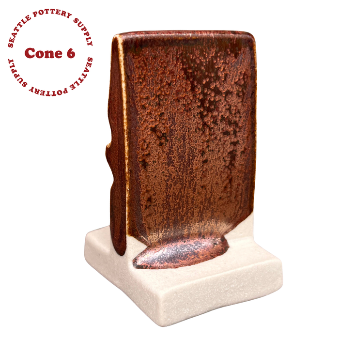 PC-56 Ancient Copper glaze on an upright test tile at cone 6, speckled rust brown pooling coppery at the base