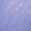 Close-up of Amaco PG-55 Floating Lavender glaze on a wavy ridged tile, glossy light purple with spotted texture