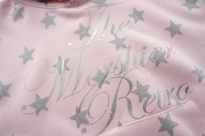 Pink star print sweatshirt front close-up with glitter script lettering