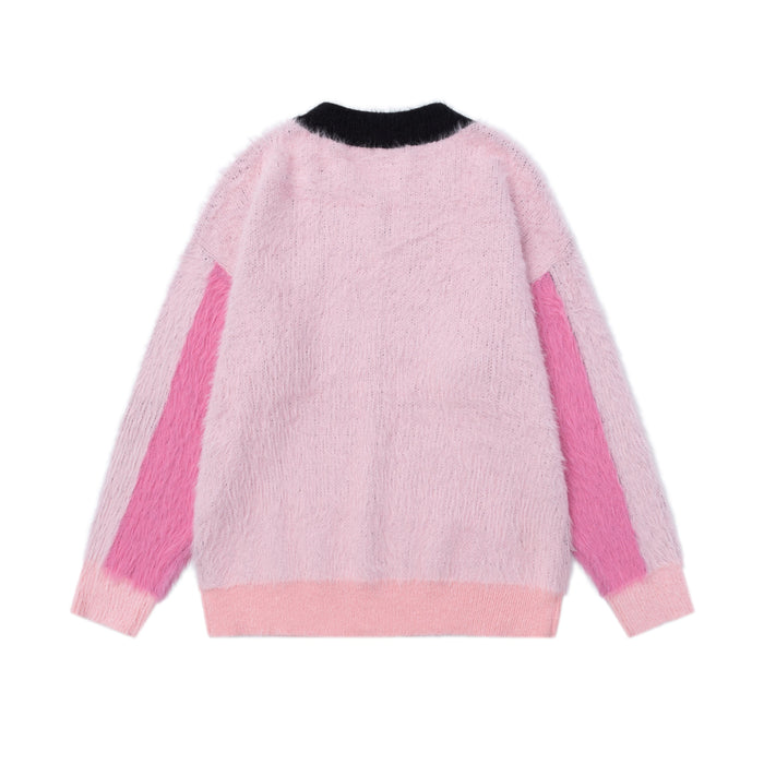 Back view of pink fuzzy knit sweater with black collar, pink side panels, and ribbed hem