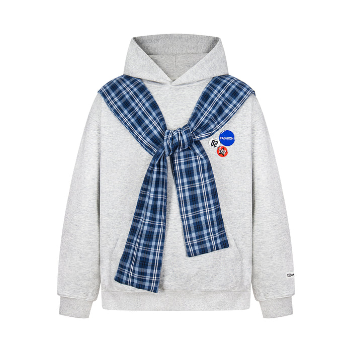Light gray hoodie with blue plaid scarf tied at the chest and three badge accents