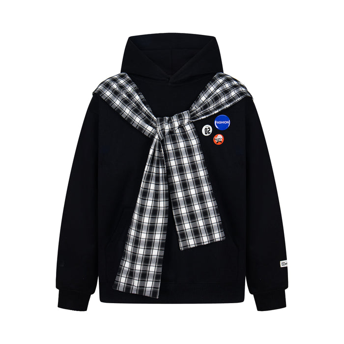 Black hoodie with black-and-white plaid scarf tied at the chest and three badge accents