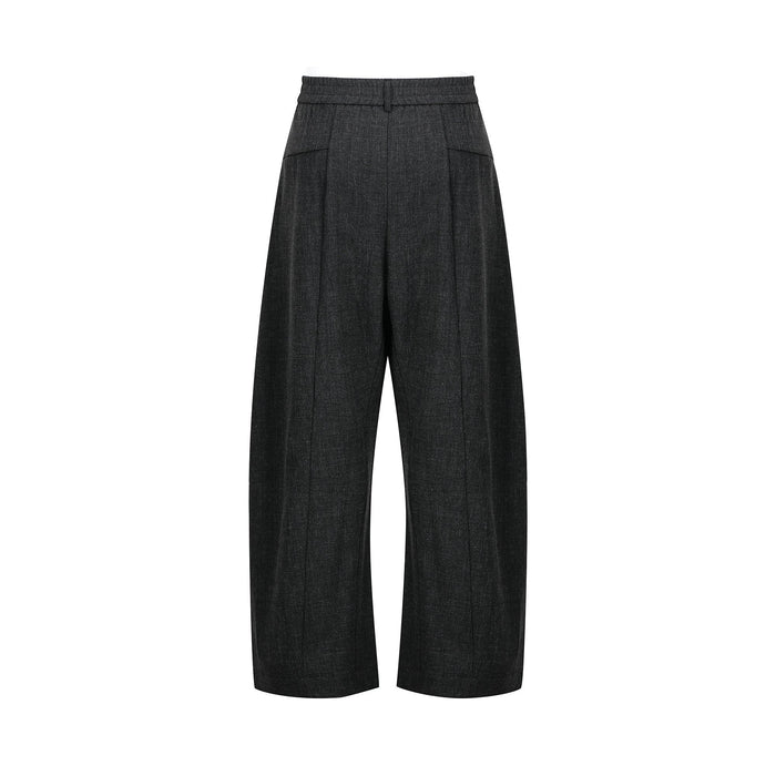 Back view of black pleated wide-leg pants with elastic waistband and side pockets