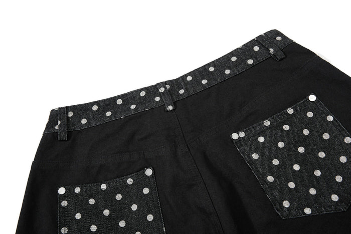 Back view of black wide-leg jeans with polka dot pocket panels and waistband
