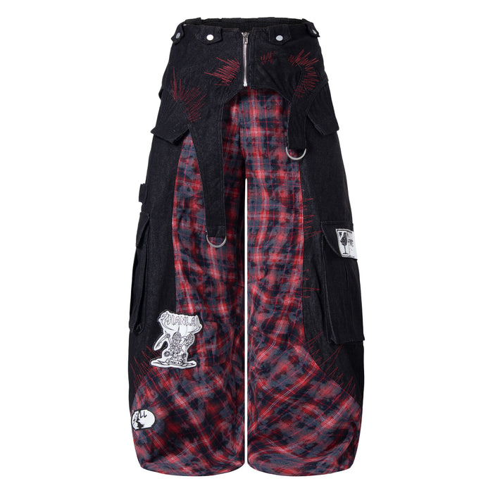 Front view of black wide-leg cargo pants with red plaid paneling and stitched graphic details