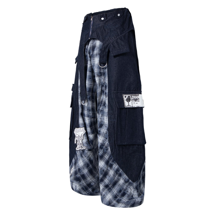 Side view of black cargo pants with gray plaid inset panels and white patch detail