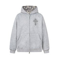 Light gray zip hoodie with rhinestone cross on chest and star-print hood lining, front view