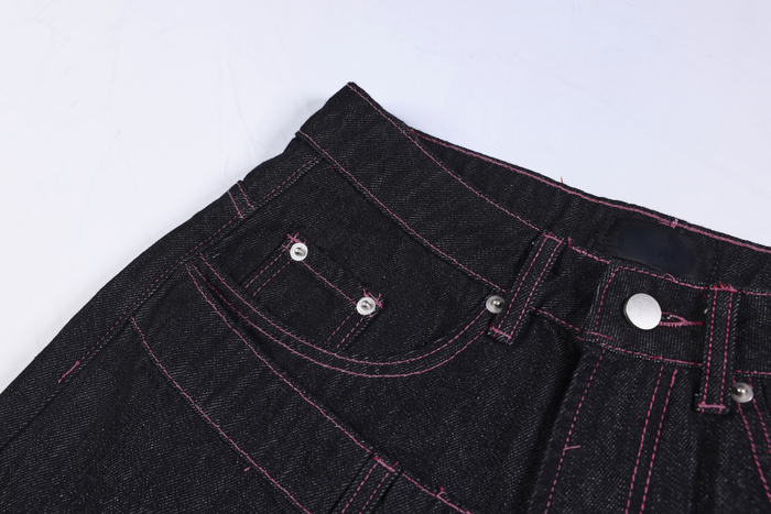 Close-up of the upper front waistband, coin pocket, and pink contrast stitching