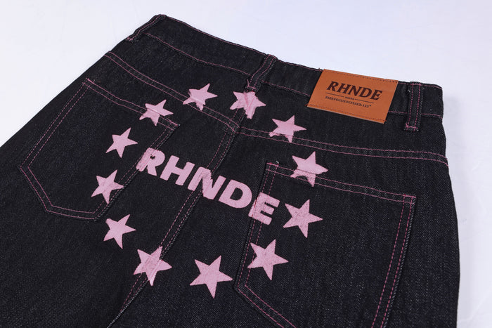 Back waistband close-up with pink star embroidery and RHNDE leather patch