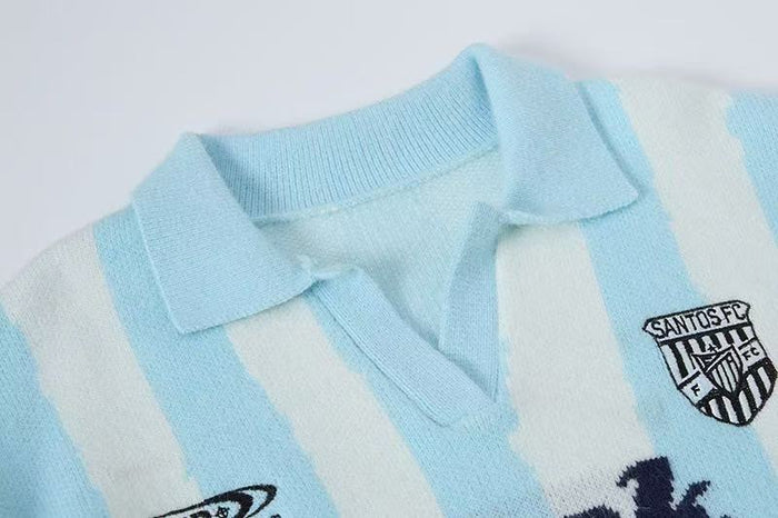Close-up of light blue striped knit polo collar and chest logo