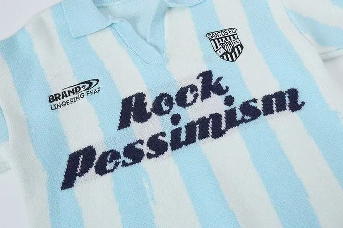 Front of light blue striped knit polo sweater with Rock Pessimism text